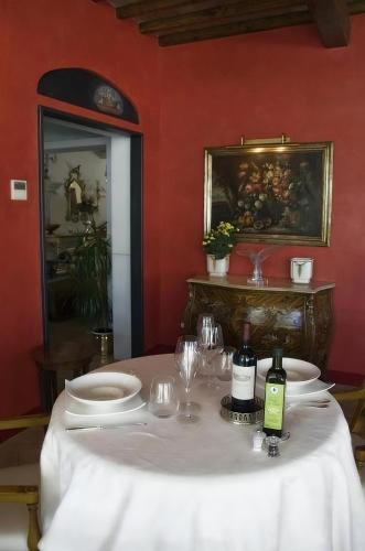 a table with white plates and wine glasses on it at Tenuta Del Gallo in Amelia