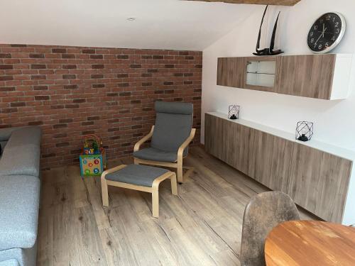 a living room with a brick wall and two chairs at Industrial Lodge 85m² - Loft avec extérieur in Revel