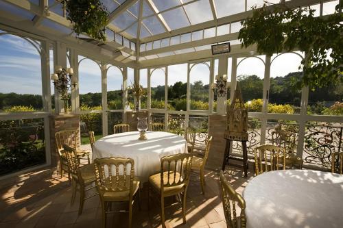 a white conservatory with a table and chairs at Tenuta Del Gallo in Amelia