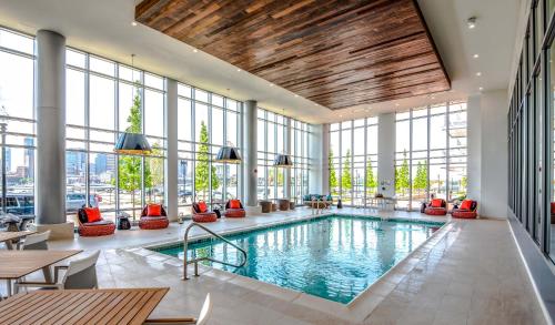 a swimming pool in a building with windows at Global Luxury Suites East Boston in Boston