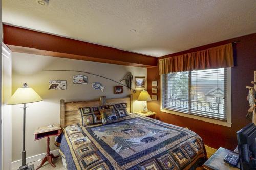 a bedroom with a bed and a window at Lazy on the Lakefront (F205) in Twin Beaches