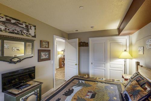 a living room with a bed and a television at Lazy on the Lakefront (F205) in Twin Beaches