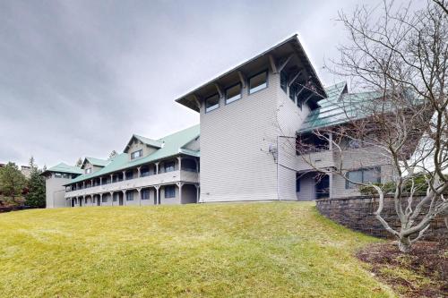 a large white building with a green roof at Lazy on the Lakefront (F205) in Twin Beaches