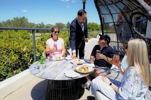 a group of people sitting around a table at Mercure Kooindah Waters Central Coast in Wyong