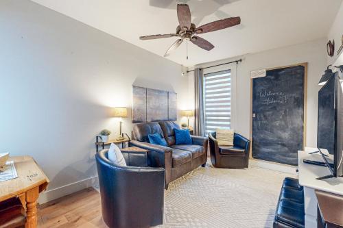 a living room with a couch and a ceiling fan at Mariner's Rest East in Anacortes