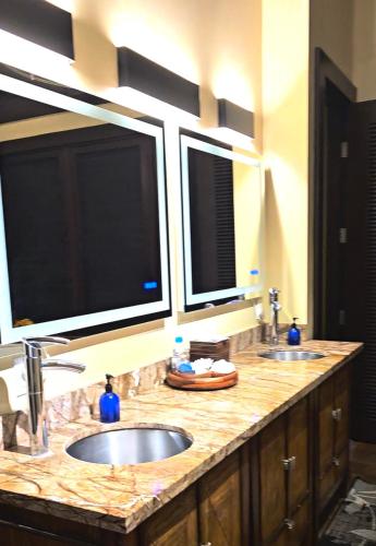 a bathroom with two sinks and two windows at One-of-a-Kind MAUI Getaway! in Wailea