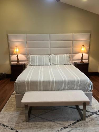 a bedroom with a large bed with two lamps at One-of-a-Kind MAUI Getaway! in Wailea