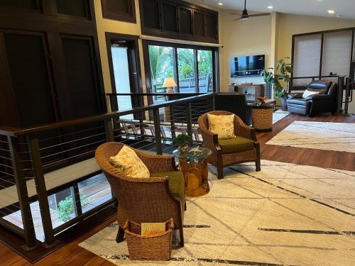 a living room with two chairs and a staircase at One-of-a-Kind MAUI Getaway! in Wailea