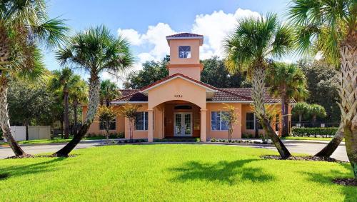 a house with a clock tower on top of a yard at Cozy home near MCO in Kissimmee