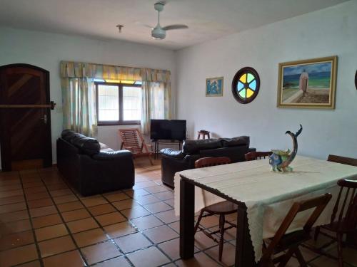 a living room with a table with a dinosaur on it at Casa no Guaraú - Peruíbe in Peruíbe
