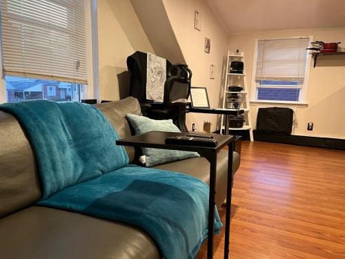 a living room with a couch and a table at Charming NYC apt near UBS and Belmont Park Village in Elmont
