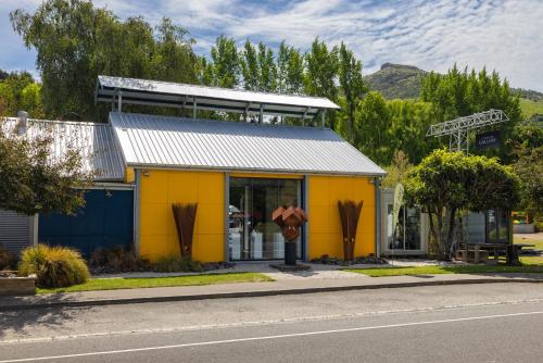 a yellow building on the side of a street at Forest View - Spacious & private full home retreat in Little River