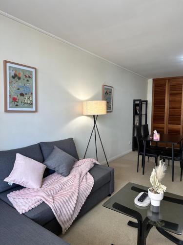 a living room with a couch and a table at North Sydney apartment with free parking in Sydney