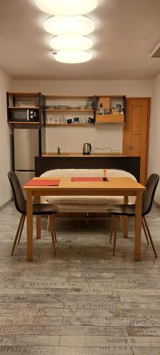 a table in a room with two chairs around it at Idyllische Wohnung im Wienerwald in Vienna