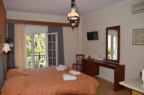 a bedroom with a bed with towels on it at Villa Vicky in Petra