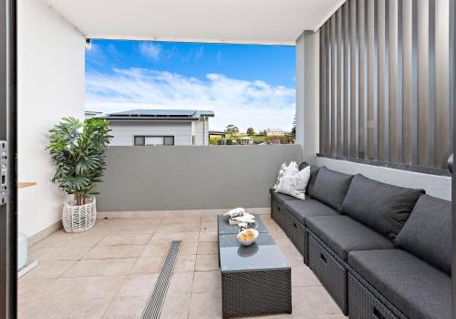 a living room with a couch and a table at Sea Dreams in Gerringong