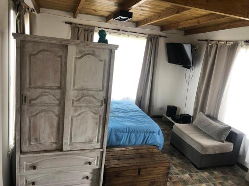 Un dormitorio con una cama y un gran armario de madera. en Portofino 43, en Santa Clara del Mar