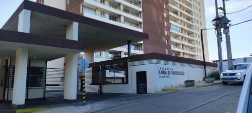 a building on a street next to a tall building at Ocean View & Pool Family Apartment 4P in Valparaíso