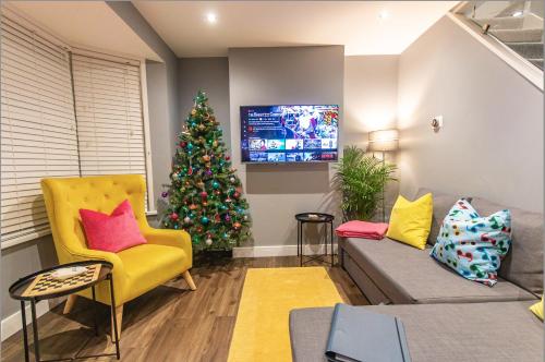 a living room with a christmas tree and a couch at Stylish home close to the BEACH By Adliv in Margate