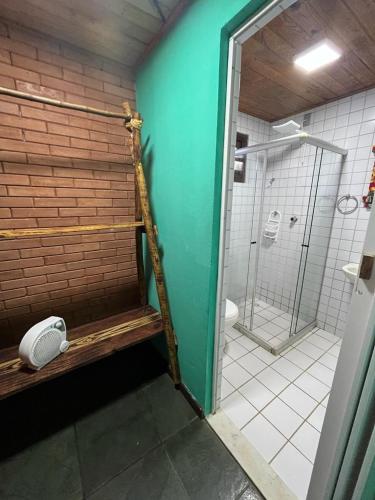 a bathroom with a shower and a toilet in it at Recanto dos Sonhos Guest House in Lumiar