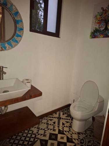 a bathroom with a toilet and a sink at Villa AHAL, in Chemuyil