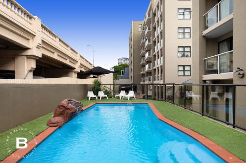 a swimming pool on the balcony of a building at City Skyline View, Urban Retreat in Brisbane