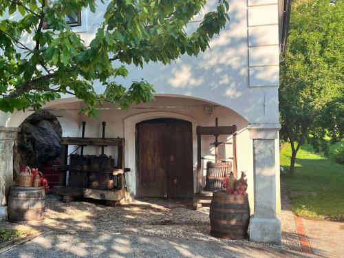 a building with a door with barrels in front of it at Holiday home in Semic - Kranjska (Krain) 51757 in Semič