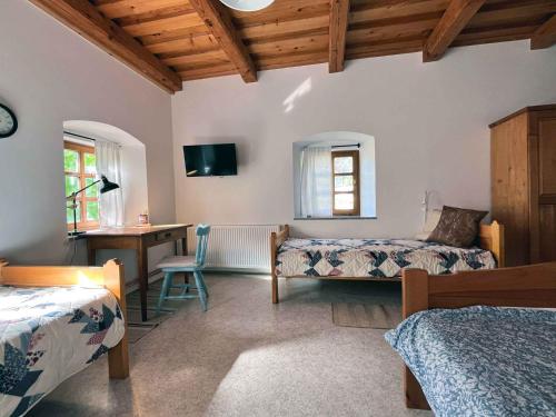 a bedroom with two beds and a desk and a table at Holiday home in Semic - Kranjska (Krain) 51757 in Semič