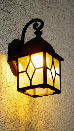 a lamp hanging on a wall with a light at Maison d'hôtes de Xavier in Brussels