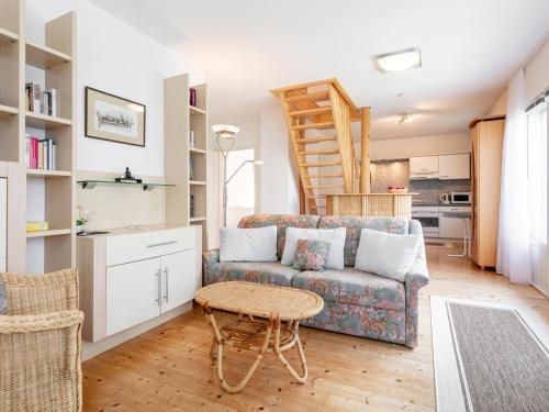 a living room with a couch and a ladder at Ferienidyll Kufstein in Kufstein