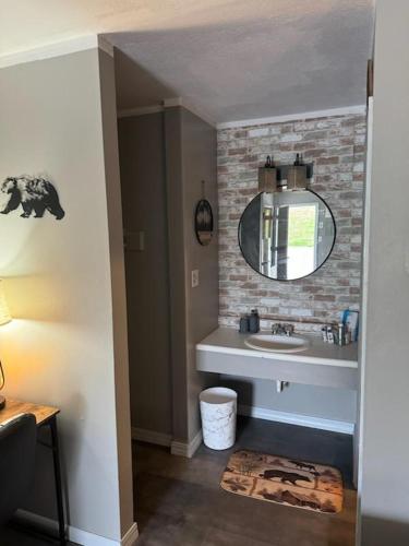 a bathroom with a sink and a mirror at White's Motel & Sports Lounge in Centerville