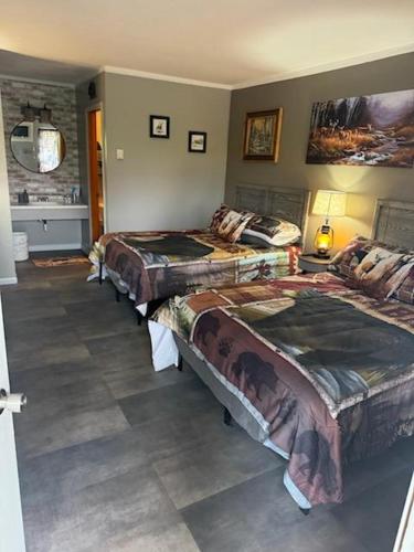 a bedroom with three beds in a room at White's Motel & Sports Lounge in Centerville