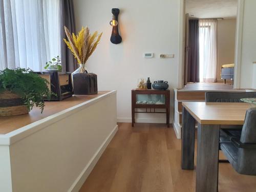 a living room with a table and a dining room at JaNa in Kaatsheuvel