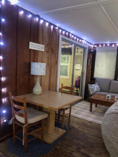 a room with a table with a lamp and a couch at Captain's Quarters in Avon