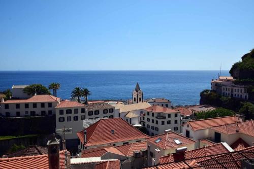 a view of a town with the ocean in the background at SUNSCAPE STUDIO - Apt 1 Quarto, Ponta do Sol in Ponta do Sol