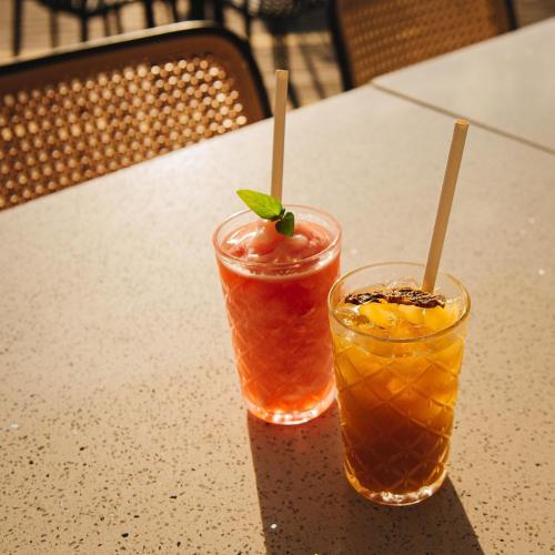 two cocktails sitting on top of a table at Natalna Boutique Home in Bacnotan