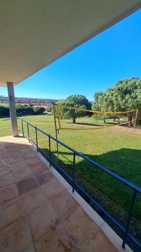 a balcony with a volleyball net and a field at Casa Oliveira in Casa da Ferraria