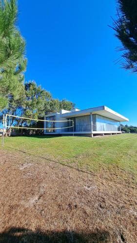 a large building with a grassy field in front of it at Casa Oliveira in Casa da Ferraria