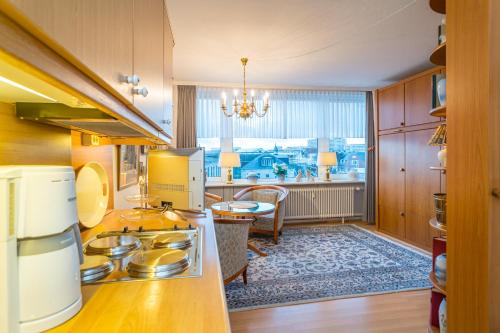 a kitchen with a stove and a dining room at Wilhelmine 26 in Westerland (Sylt)