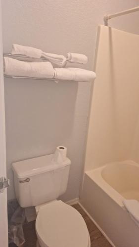 a white bathroom with a toilet and a bath tub at 82A Grand Canyon South Rim Studio Sleeps 2 in Valle