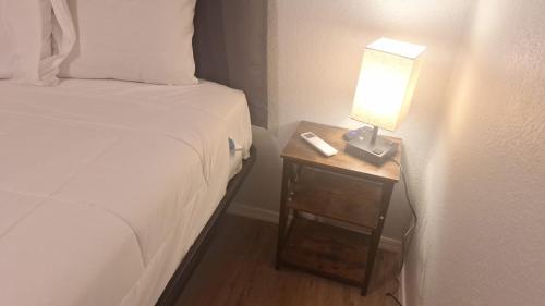 a bed and a nightstand with a lamp on it at 82A Grand Canyon South Rim Studio Sleeps 2 in Valle