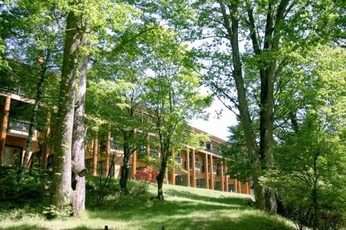 a school building with trees in front of it at Chuzenji Kanaya Hotel in Nikko
