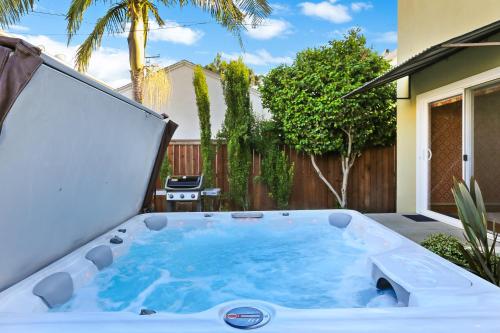a hot tub in the backyard of a house at Beach Villa * Hot Tub * Steps to Beach in Long Beach