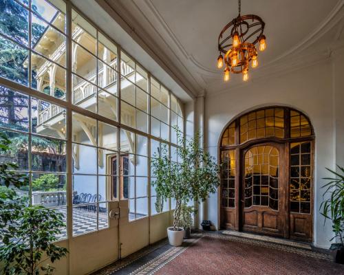 a hallway with a large glass door and a chandelier at Heart of Tbilisi in Tbilisi City