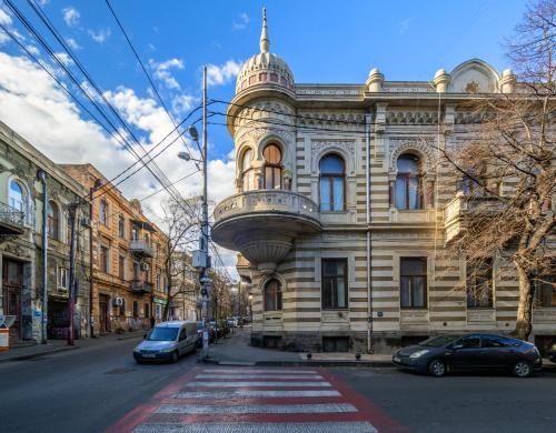 a building on a street with cars parked in front of it at Heart of Tbilisi in Tbilisi City