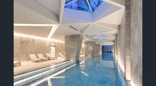 a lobby with a pool of water in a building at Gorgeous City Views 64th Floor 3BR APT with Pool & Gym in Melbourne