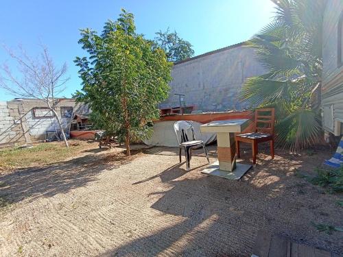 a patio with a table and chairs and a tree at Peaceful and Cozy Camper in the City Center with Private Patio in Cabo San Lucas
