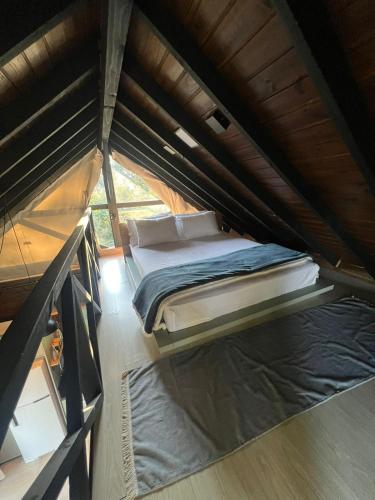 a bed in the middle of a tent at Cabana Trinca Ferro in São Pedro de Alcântara