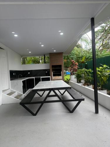 a dining room with a table in the middle of a room at Casa Tucan 2bdr beach house AC BBQ Playa Blanca in Puerto Jiménez