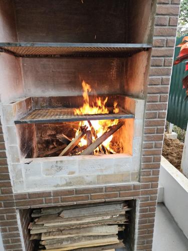 a brick oven with a fire in it at Casa Tucan 2bdr beach house AC BBQ Playa Blanca in Puerto Jiménez